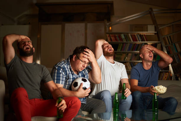 Men watching soccer stock photo