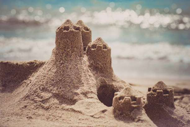istock Sand castle standing on the beach. Travel vacations concept. 869419918