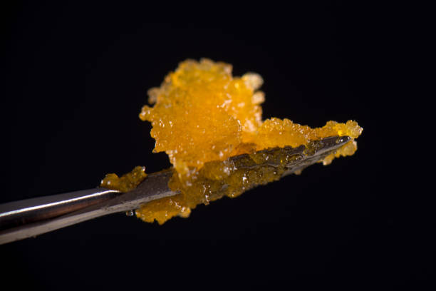 Dannabis concentrate live resin (extracted from medical marijuana) isolated over black - fotografia de stock