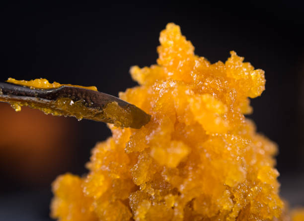 Cannabis concentrate live resin (extracted from medical marijuana) with a dabbing tool stock photo