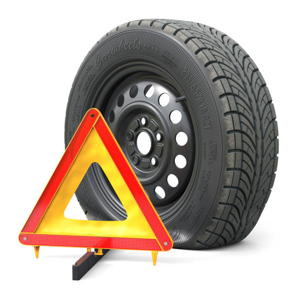 istock The punctured automobile wheel and emergency warning triangle sign 869424124