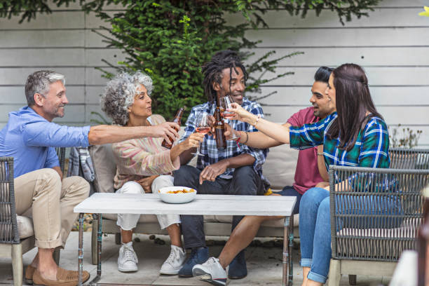 istock Happy friends toasting drinks at garden party 869424186