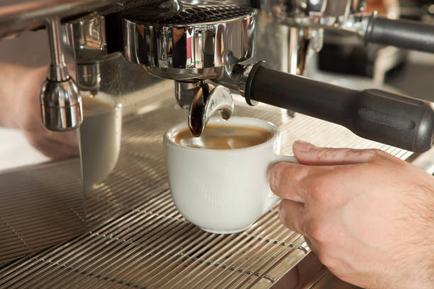 istock Close-up of espresso pouring from coffee machine 869433288