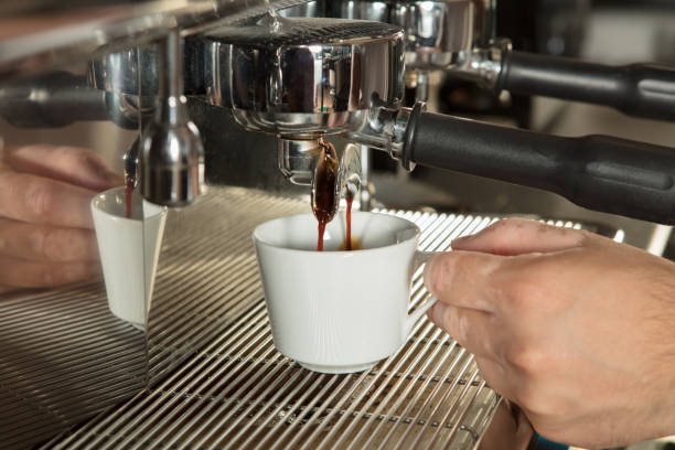 Close-up of espresso pouring from coffee machine stock photo