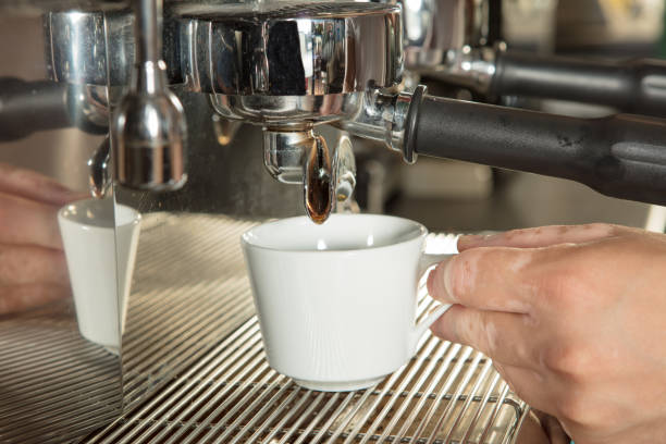 Close-up of espresso pouring from coffee machine stock photo