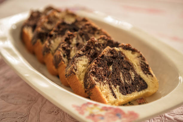 Slices of homemade chocolate marble cake on a porcelain plate stock photo