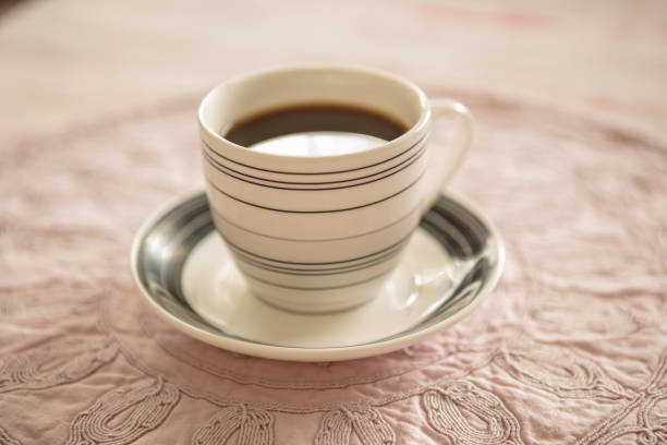 A cup of instant coffee place on old cloth napkin