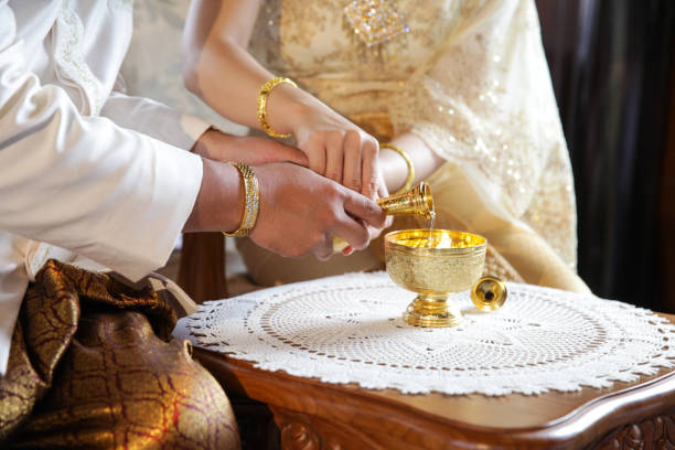 istock libation, Thai engagement, pour water in Thai wedding, pouring water in Thai wedding 869449376