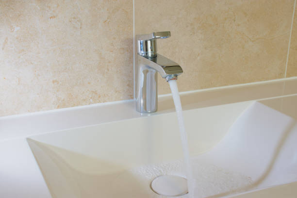 istock Tap with running water in the bathroom 869449484
