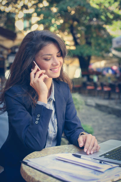 istock Smiling business woman talking phone. 869452896