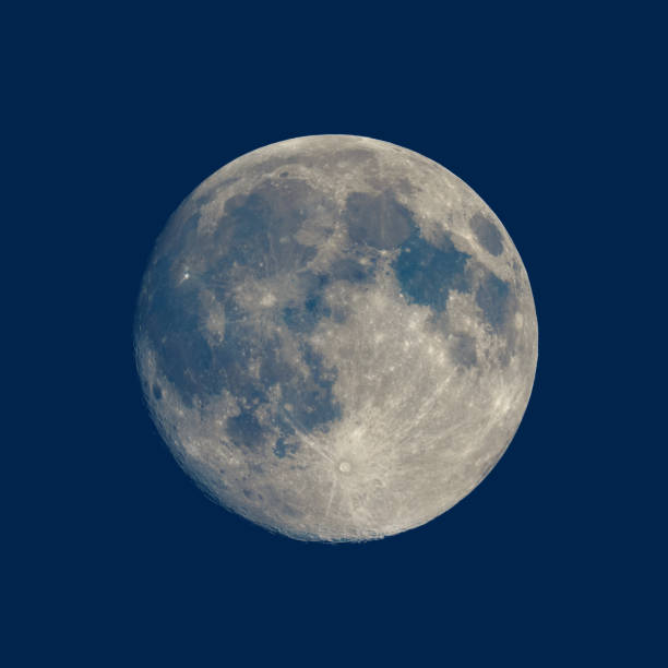istock Full moon seen with telescope over blue 869452958