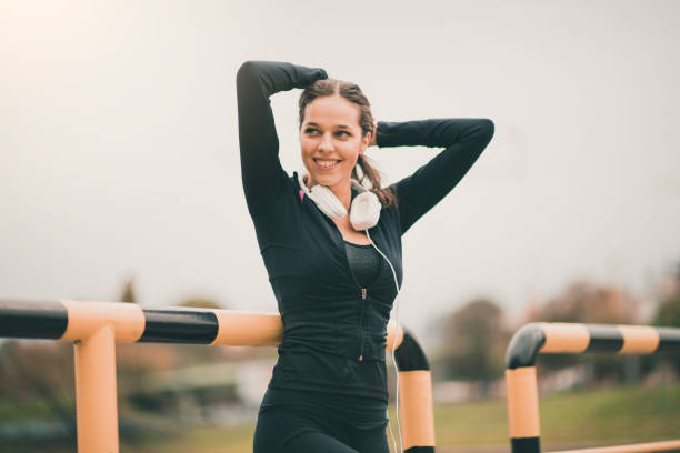 istock Sportswoman posing while holding her arms above head 869455470