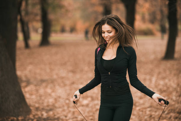 istock Sportswoman exercising on jumping rope 869455570