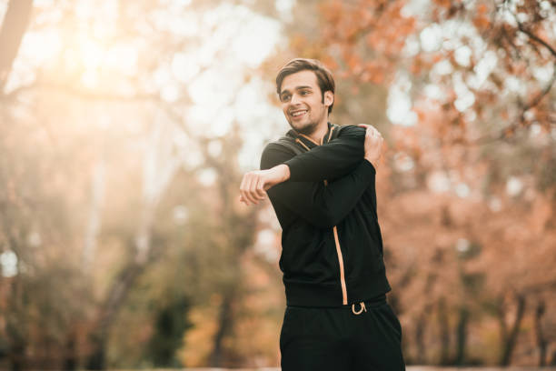 istock Sportsman stretching his left arm in the woods 869455606