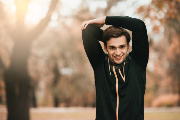 istock Sportsman holding his arms above the head while stretching them 869455892