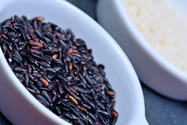 istock Bowls with black and white rice on slate 869455996