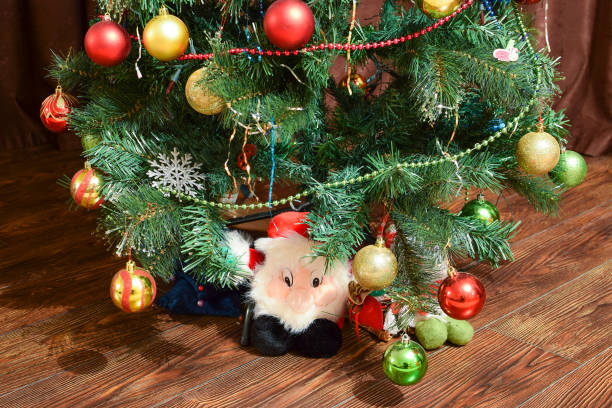 Christmas toys and ornaments on the Christmas tree Christmas toys and ornaments on the Christmas tree. Tinsel, balls and toys decorated fir. dwarf pine trees stock pictures, royalty-free photos & images