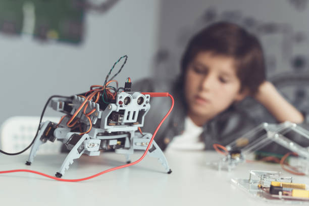 istock The boy creates a robot. He measures his data with a multimeter. The boy observes the measurements 869462434