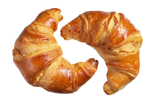 Two fresh croissants isolated on a white background
