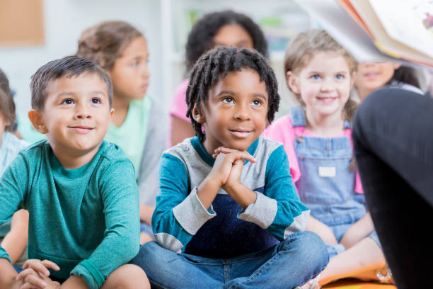 istock Attentive elementary age class listens to story 869475990