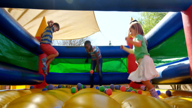 Kids playing on the bouncing castle 4k