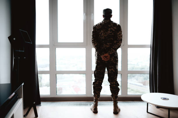 istock A man in uniform wears a large panoramic window and holds his hands behind his back. 869485520