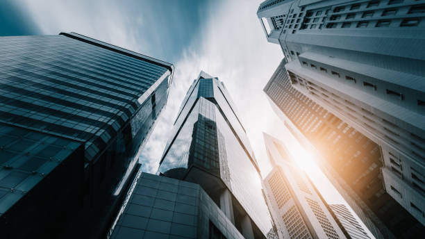istock Bottom view to skyscrapers at downtown district. Clouds in motion 869489948