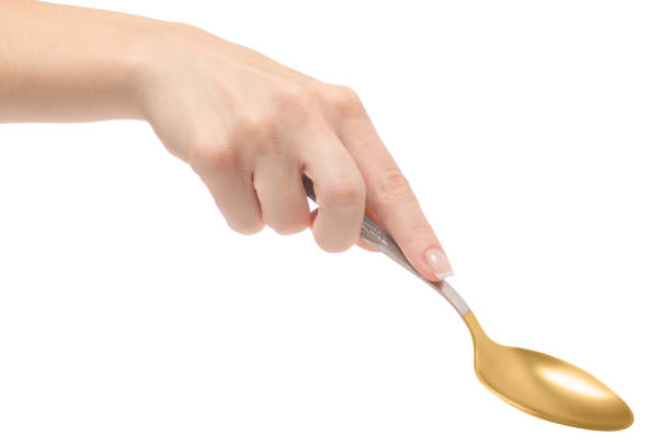istock Female hand holding a spoon 869493072