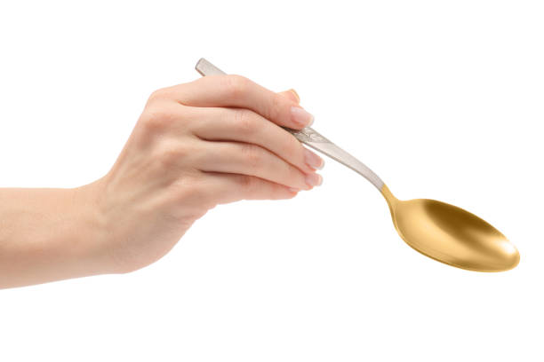 istock Female hand holding a spoon 869493146