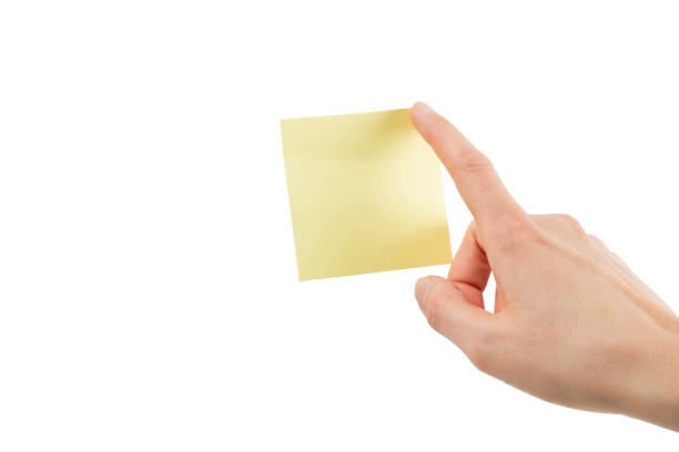 Female hand with yellow sticky note – Isolated with clipping path