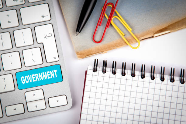 istock Government concept. Computer keyboard on a white office desk with various items 869496172