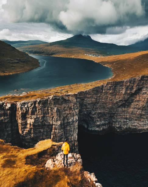 istock man on top of the cliff at Faroe islands 869496196