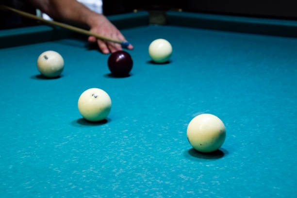 istock Billiards, billiard table. Targeting the cue in the ball for impact 869502702