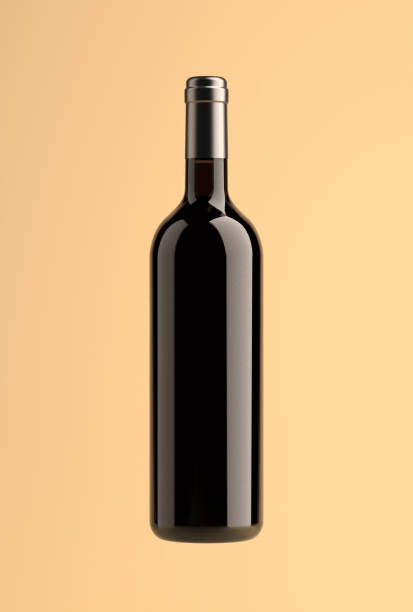 bottle of red wine isolated on a yellow background, silver cap