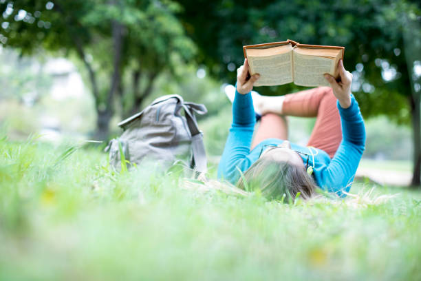 Young woman reading book at outdoor