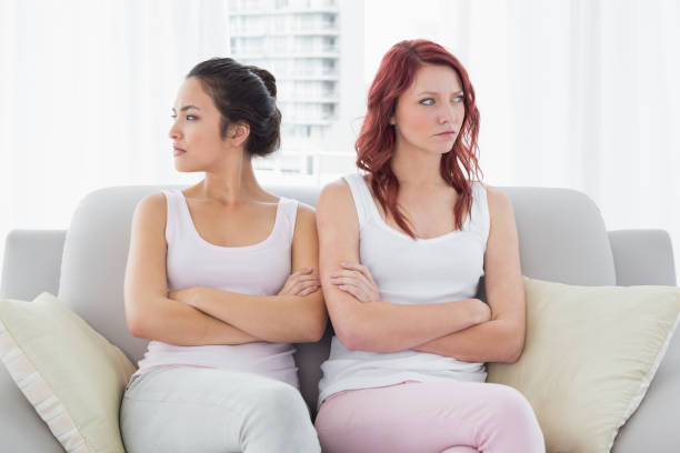 istock Unhappy friends not talking after argument at home 869513670
