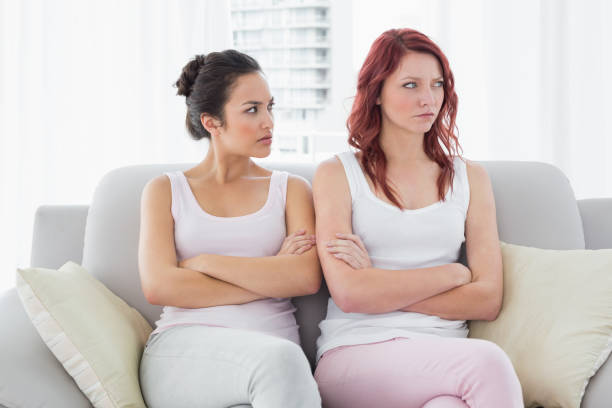 istock Unhappy friends not talking after argument at home 869513710
