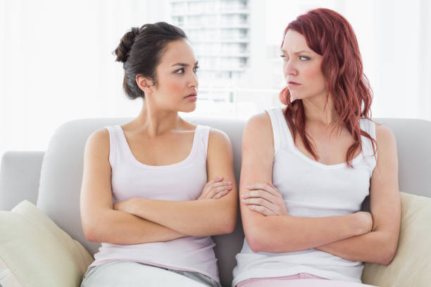 Unhappy friends not talking after argument at home