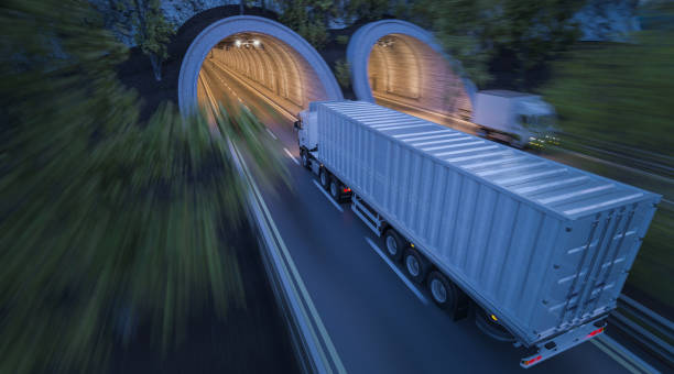 istock Tunnels Side by Side with Commercial Trucks in Motion 869519990