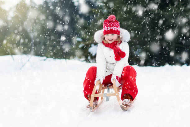 istock Child sledding. Kid with sledge. Winter snow fun. 869523664