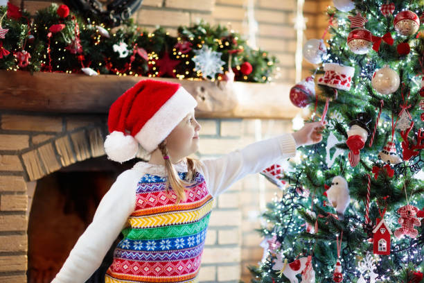 istock Child at Christmas tree. Kid at fireplace on Xmas 869524662