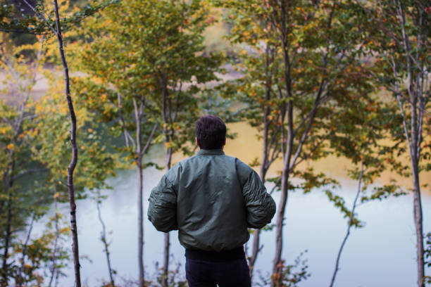 istock A man standing by the lake 869530148