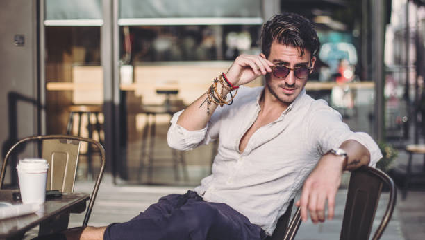 istock Elegant man sitting in cafe 869533772