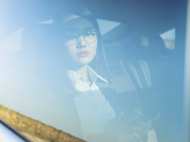 istock young businesswoman using cellphone on car backseat 869534602