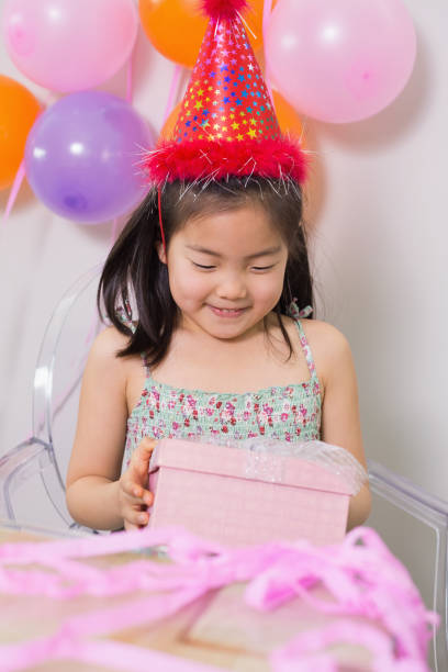 istock Little girl with gift box at her birthday party 869534764