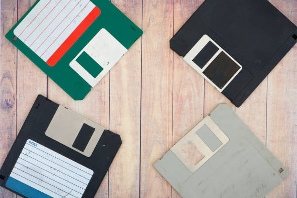 istock Old diskettes on a wooden pallet background 869538486