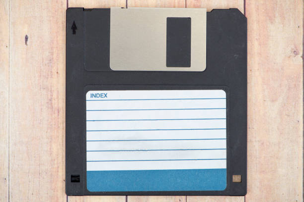 istock Old diskettes on a wooden pallet background 869538494