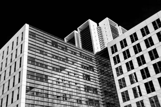 istock Abstract black and white image of glass skyscraper office buildings 869538552