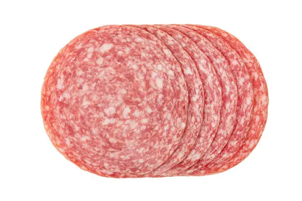 Sliced summer sausage salami isolated on white background, top view