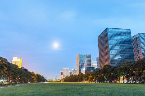 istock modern buildings with green space in nightfall 869541950